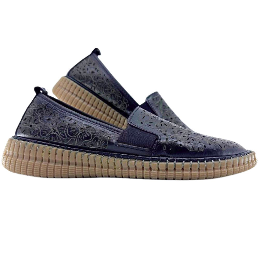 Black slip-on shoes with tan soles on a white background