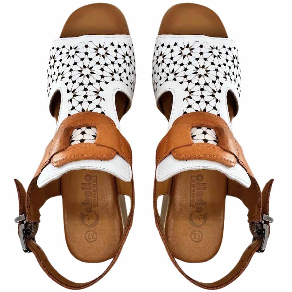 A pair of women's low-heeled block sandals shown from a top-down view. The sandals feature a white upper strap with a floral laser-cut pattern and tan leather straps against a white background.