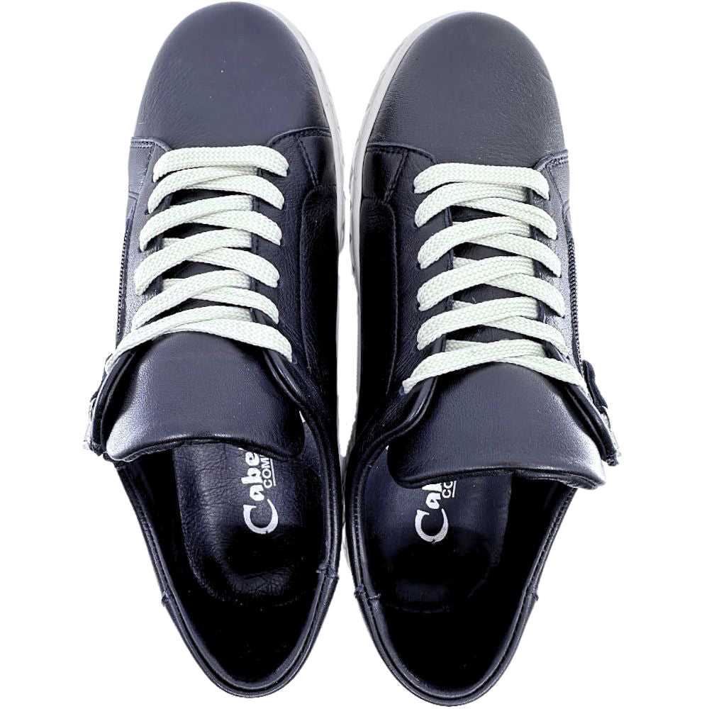 Pair of black sneakers with beige laces on a white background