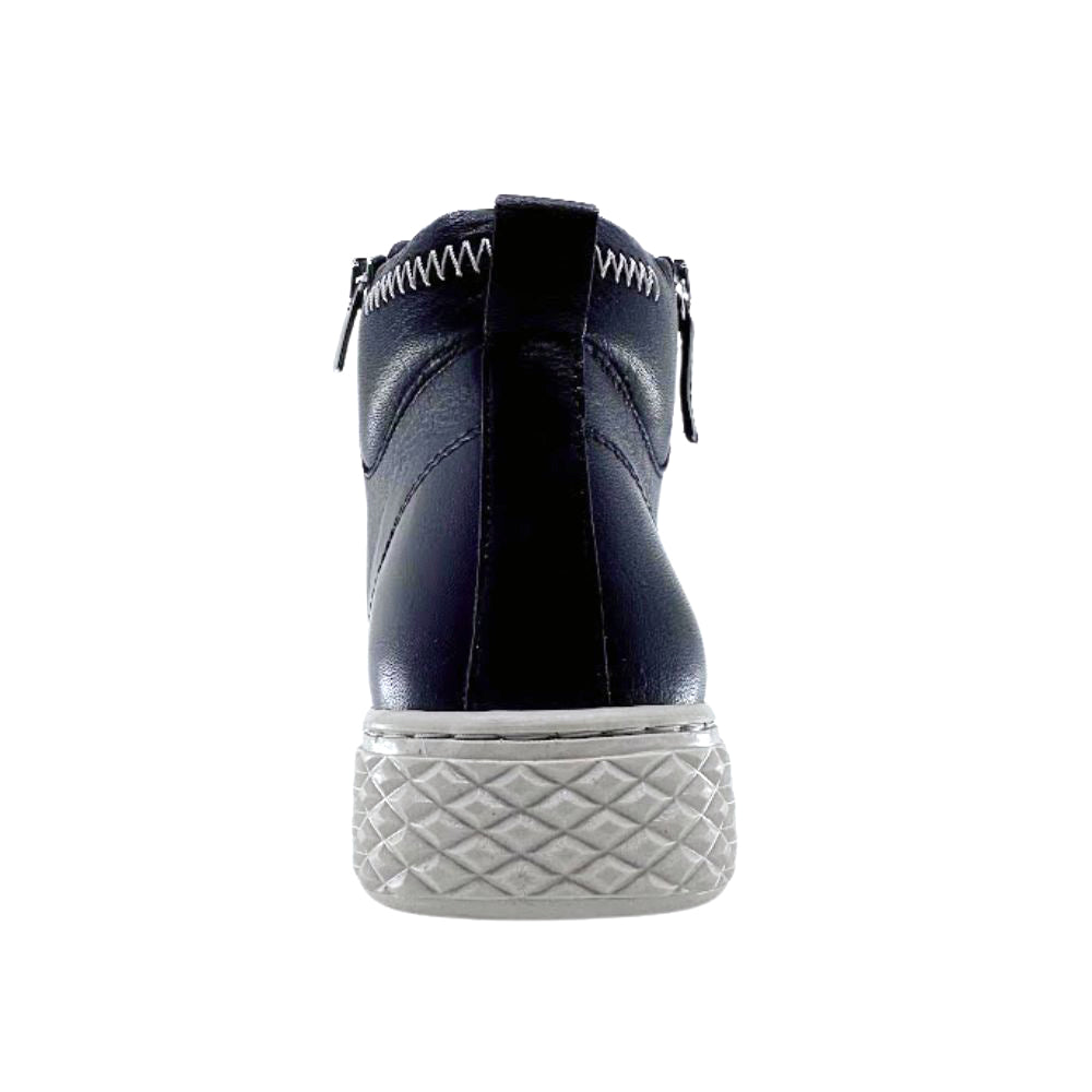 Back of black leather ankle boot with white sole on a white background