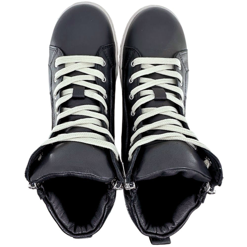 Pair of black leather ankle boots with white laces on a white background