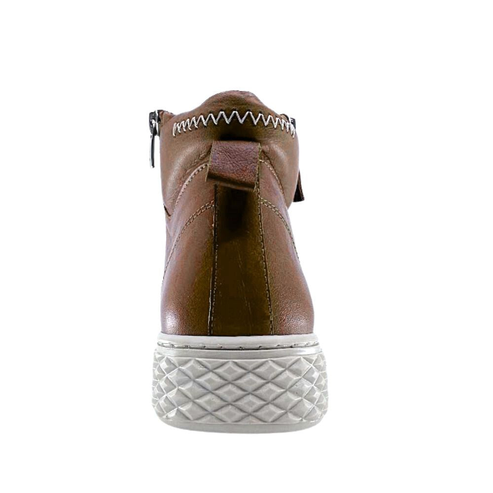 Tan leather ankle boot with white sole on a white background