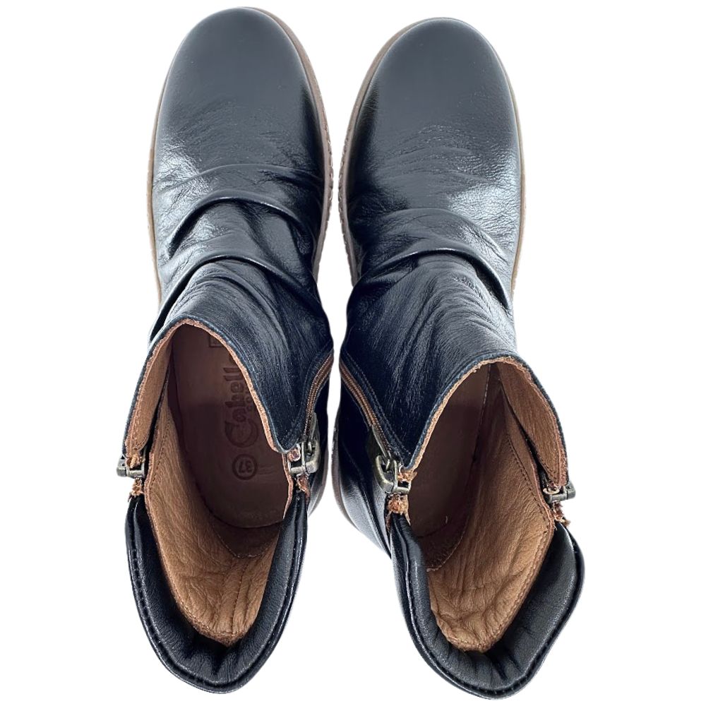 Pair of black leather boots with brown leather lining on a white background
