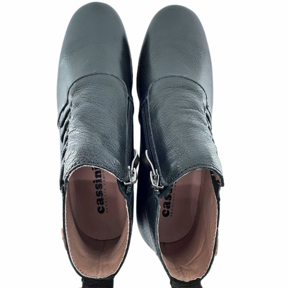 Pair of black leather shoes with a visible brand name on a white background
