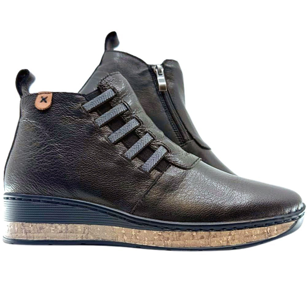 Pair of brown leather boots with a cork sole on a white background
