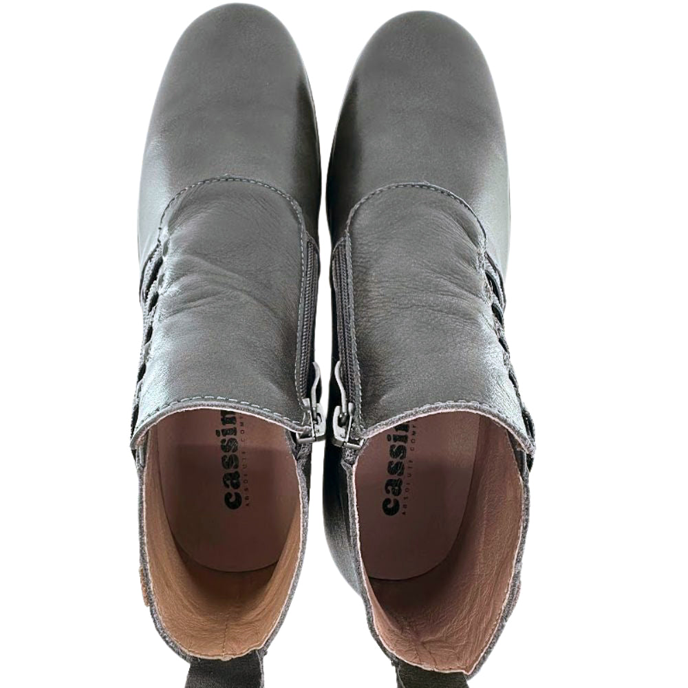 Pair of dark brown leather ankle boots with 'Cassini' branding on a white background