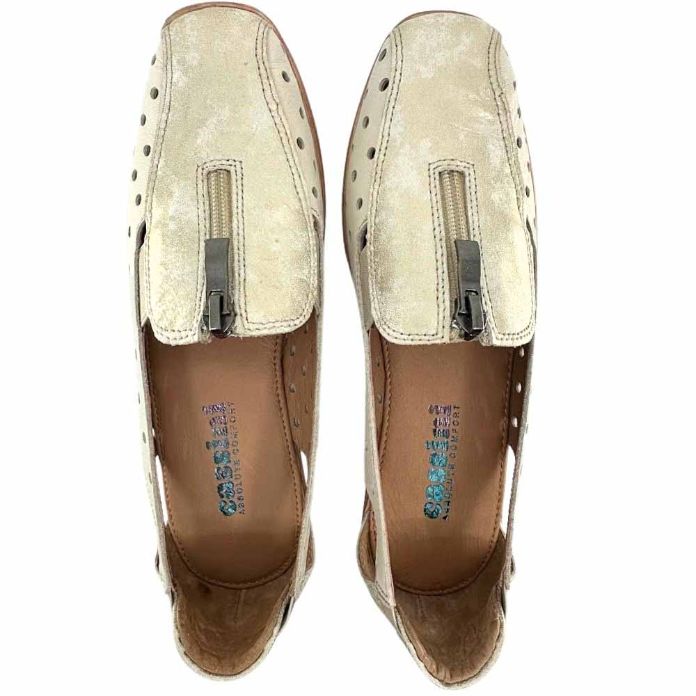 A pair of beige perforated leather slip on shoes with a gold mottle embellished upper and central zip, shown from a top-down perspective against a white background.