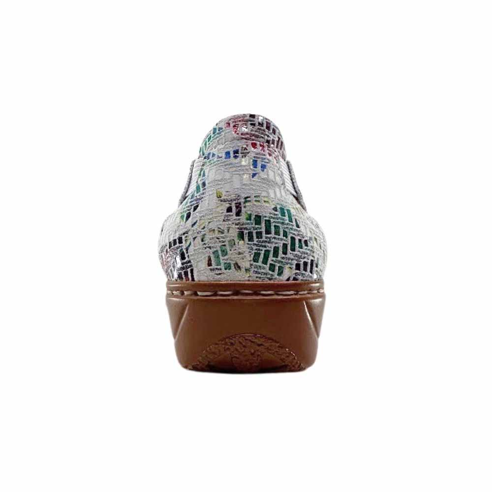 The back of a slip on shoe with a multicoloured leather heel counter and a low brown wedge sole, against a white background.