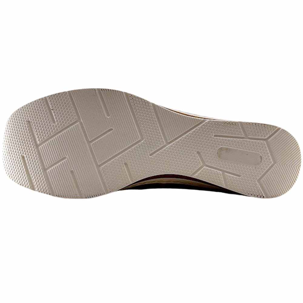 The outsole of a sneaker, showing a textured beige rubber tread with geometric patterns, photographed against a solid white background.