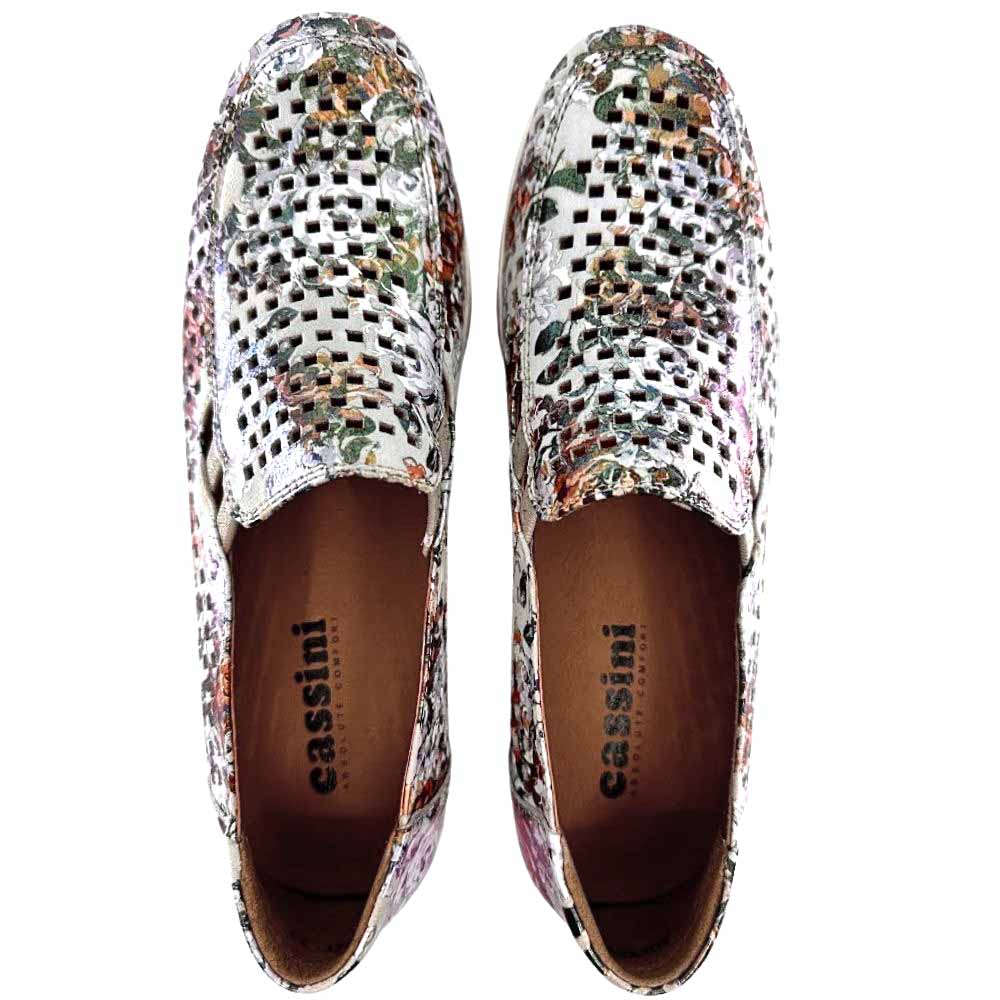 A pair of women's slip-on wedge shoes in a metallic floral rose leather with a geometric perforated pattern, from a top-down perspective against a white background.