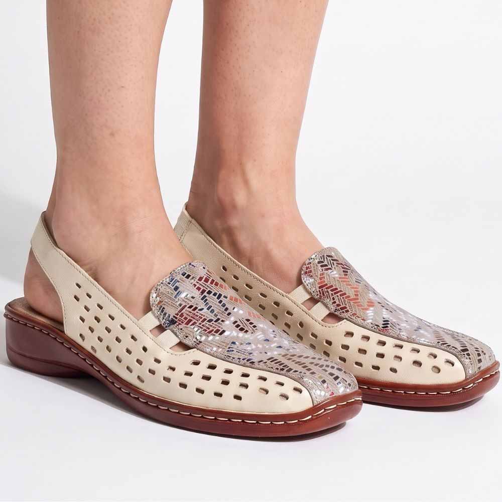 Cream perforated leather slingback sandal with a multicolour upper and a brown low wedge outsole, worn by a model against a studio background.