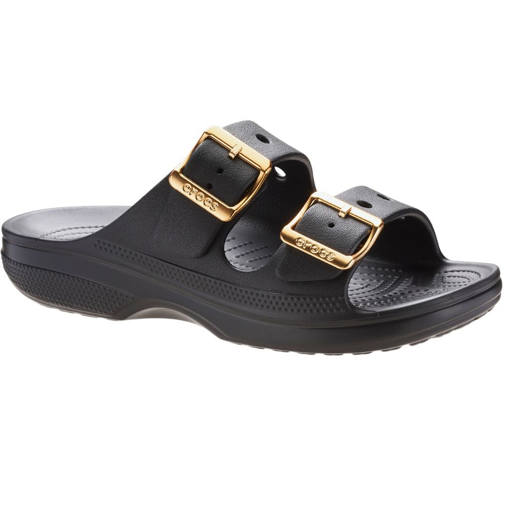 A pair of black double-strap slide sandals with gold-tone buckle straps, shown from a side profile view on a white background.