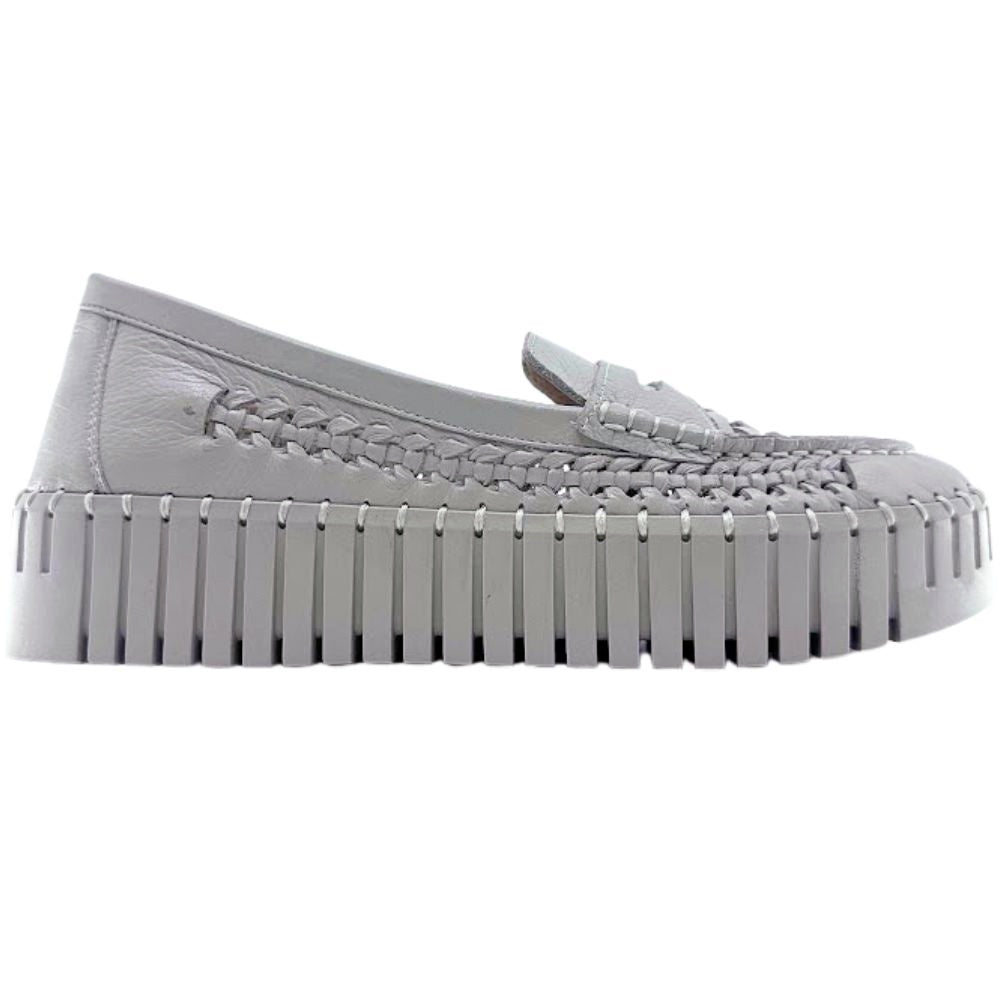 Beige woven leather loafer with a textured sole on a white background