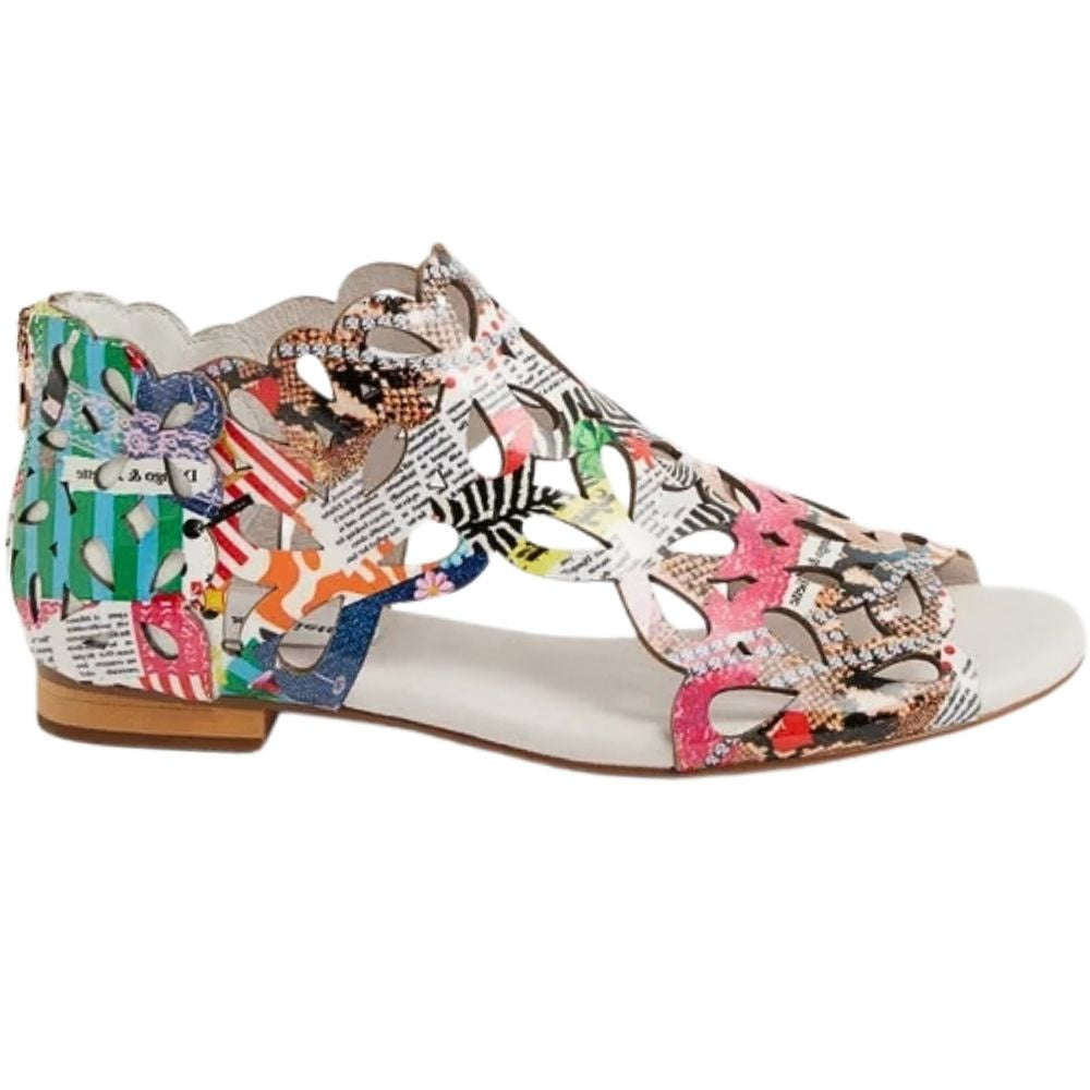 A single women's flat sandal with a multicolor collage print upper, featuring cutout straps over a white footbed and a low tan block heel, shown on a plain white background.