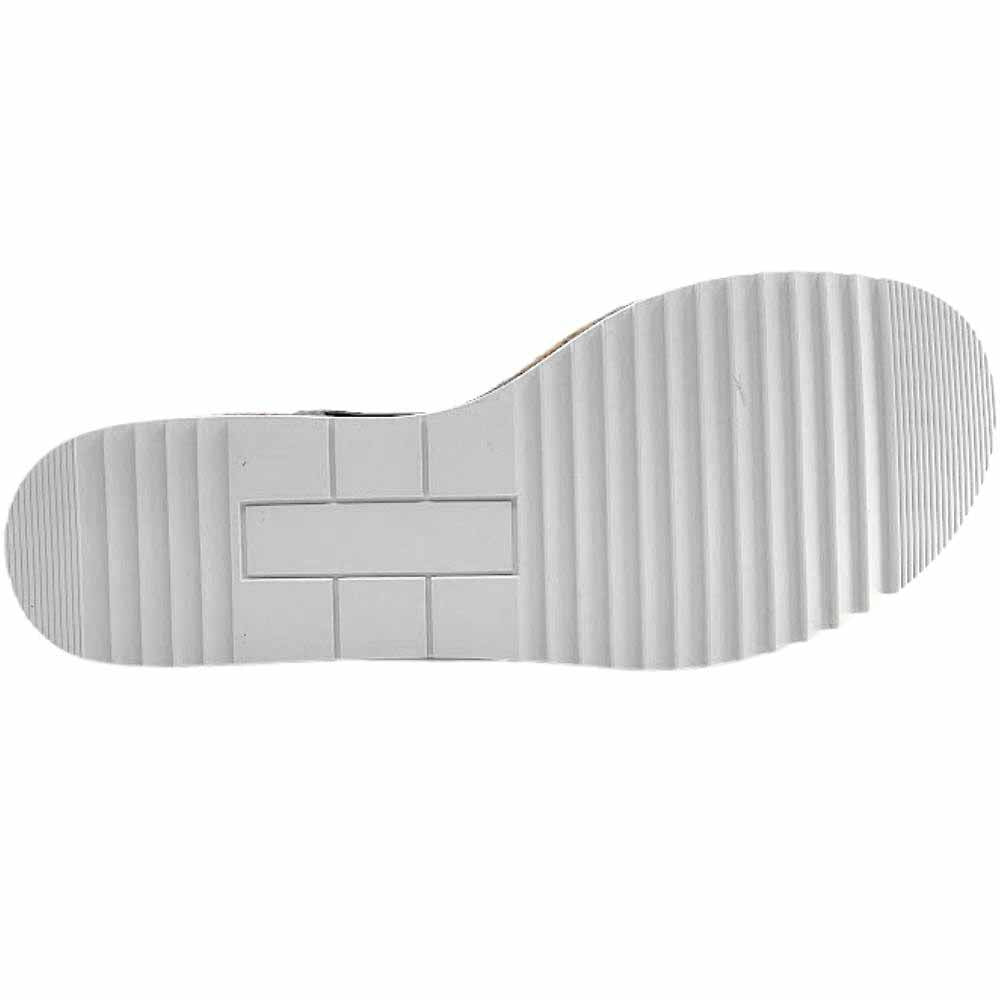 White rubber outsole of a wedge sandal showing a tread pattern, against a white background.