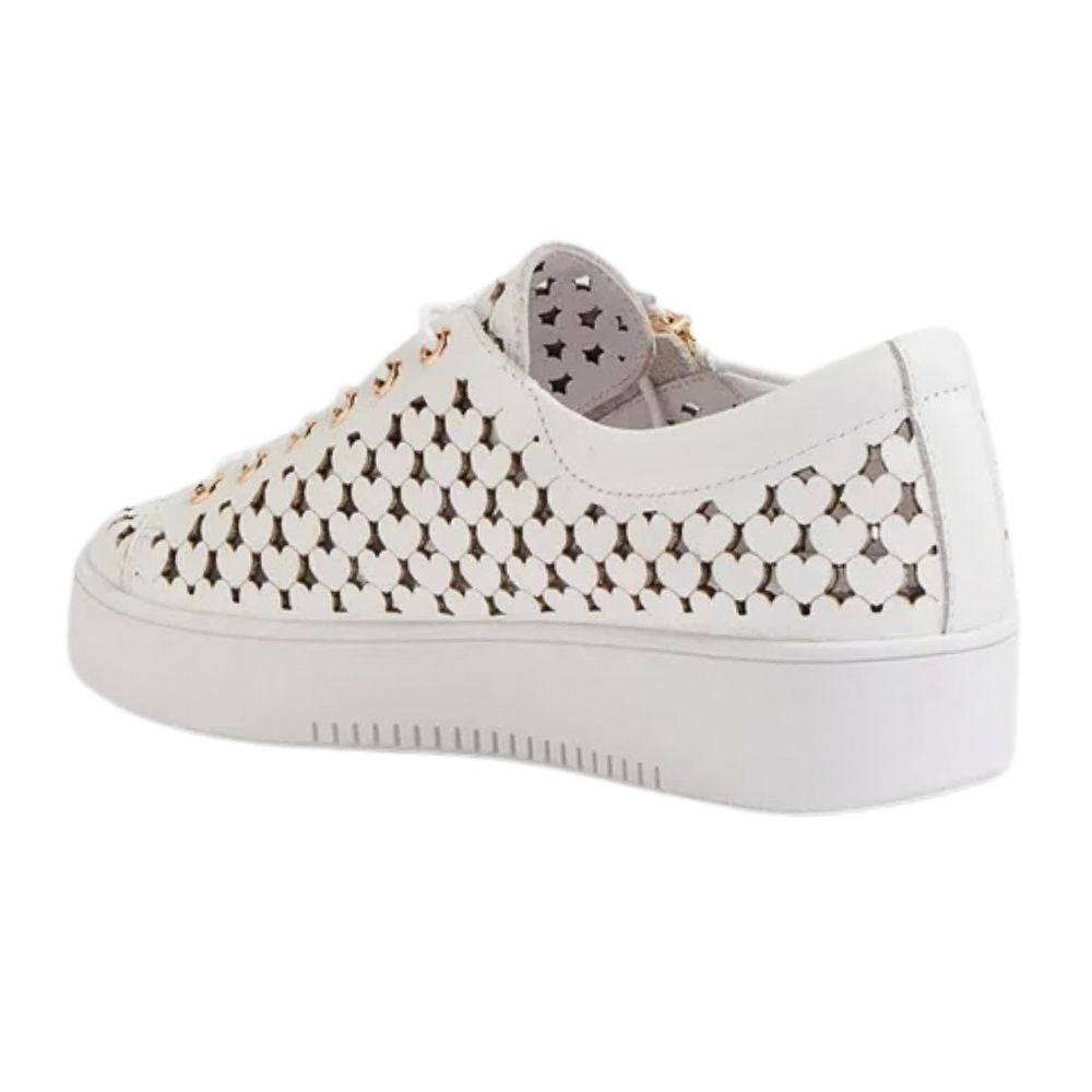 A white low-top sneaker with a heart shaped cutout pattern on the toe box and side panels, featuring a thick white platform sole and white laces.