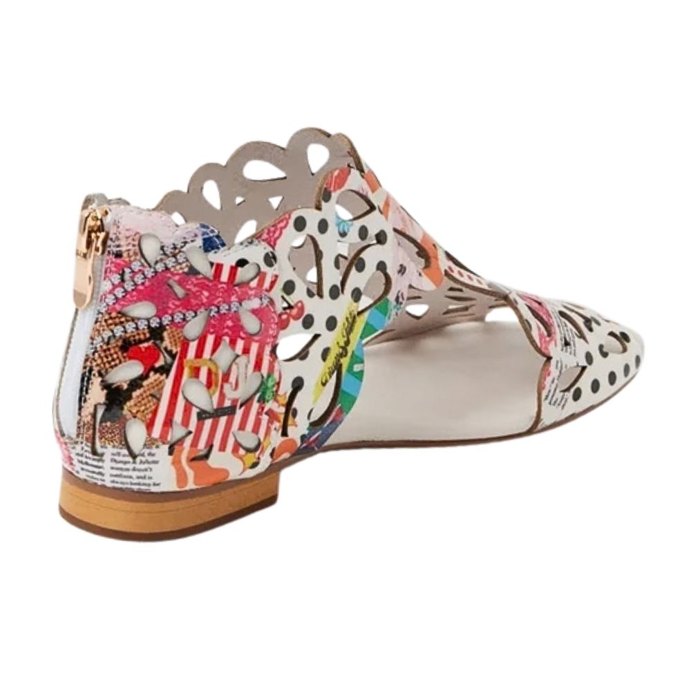 A single women's flat shoe shown from a three-quarter rear angle on a white background. The shoe features a white insole, a scalloped edge, and a highly colorful, busy collage print on the heel counter.