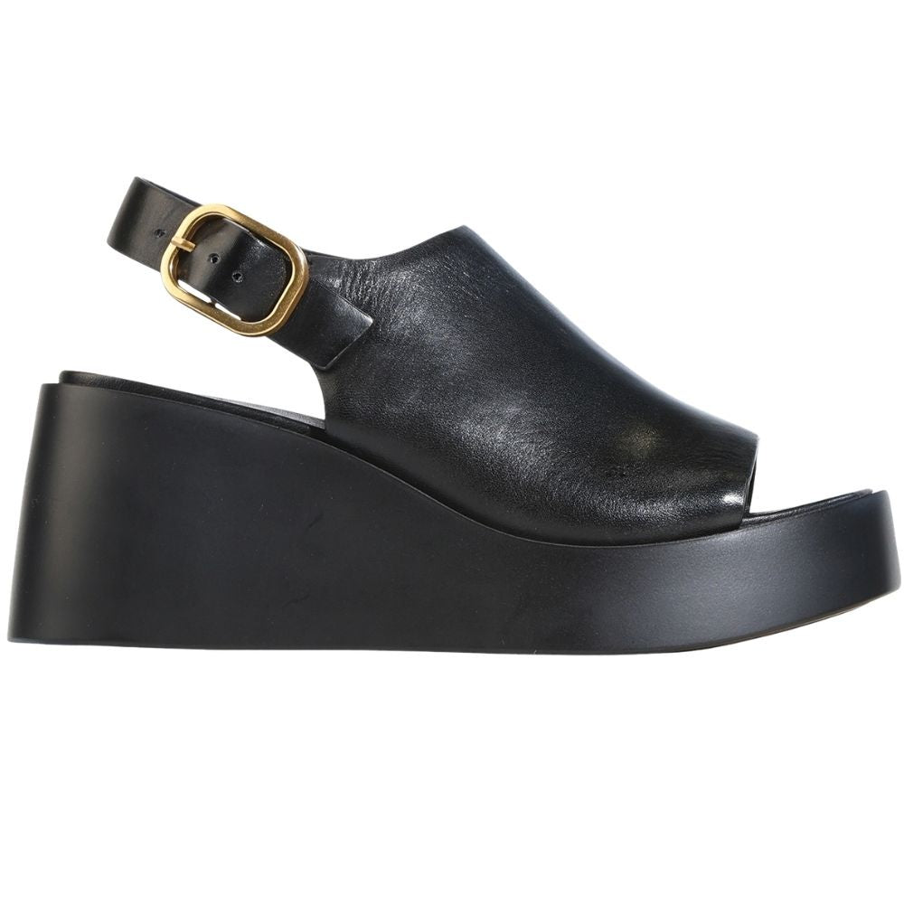 A black leather platform sandal with an ankle strap and a gold-tone buckle, shown in a side profile view against a plain white background.