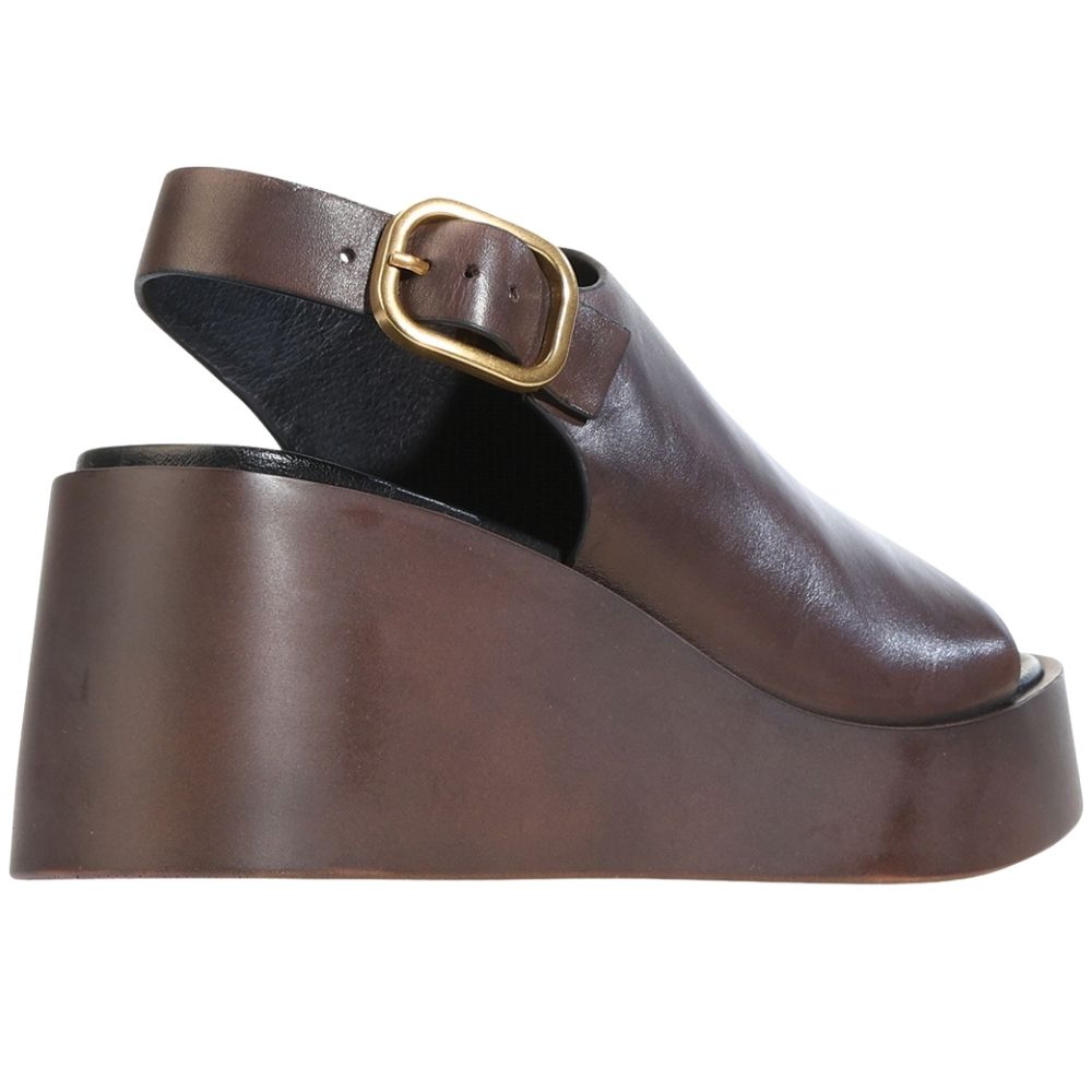 A dark brown leather platform wedge sandal with a single strap and a gold-tone buckle, shown from a side profile view against a white background.