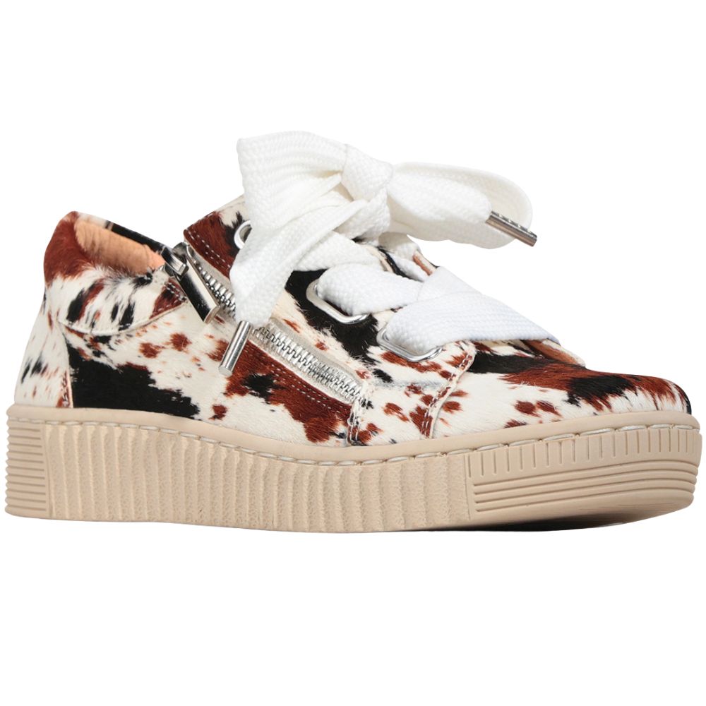 Sneaker with cow print pattern on a white background