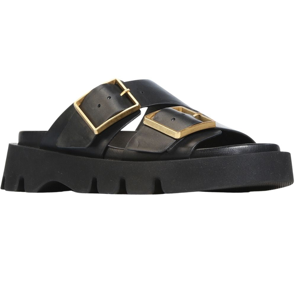 A single black leather slide sandal with chunky lug soles and two prominent gold-tone square buckle straps, shown in a side profile on a white background.