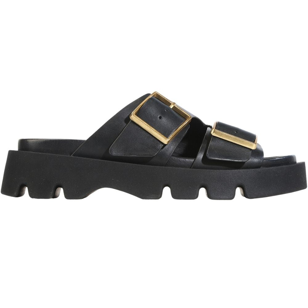 A single black leather slide sandal with chunky lug soles and two prominent gold-tone square buckle straps, shown in a side profile on a white background.