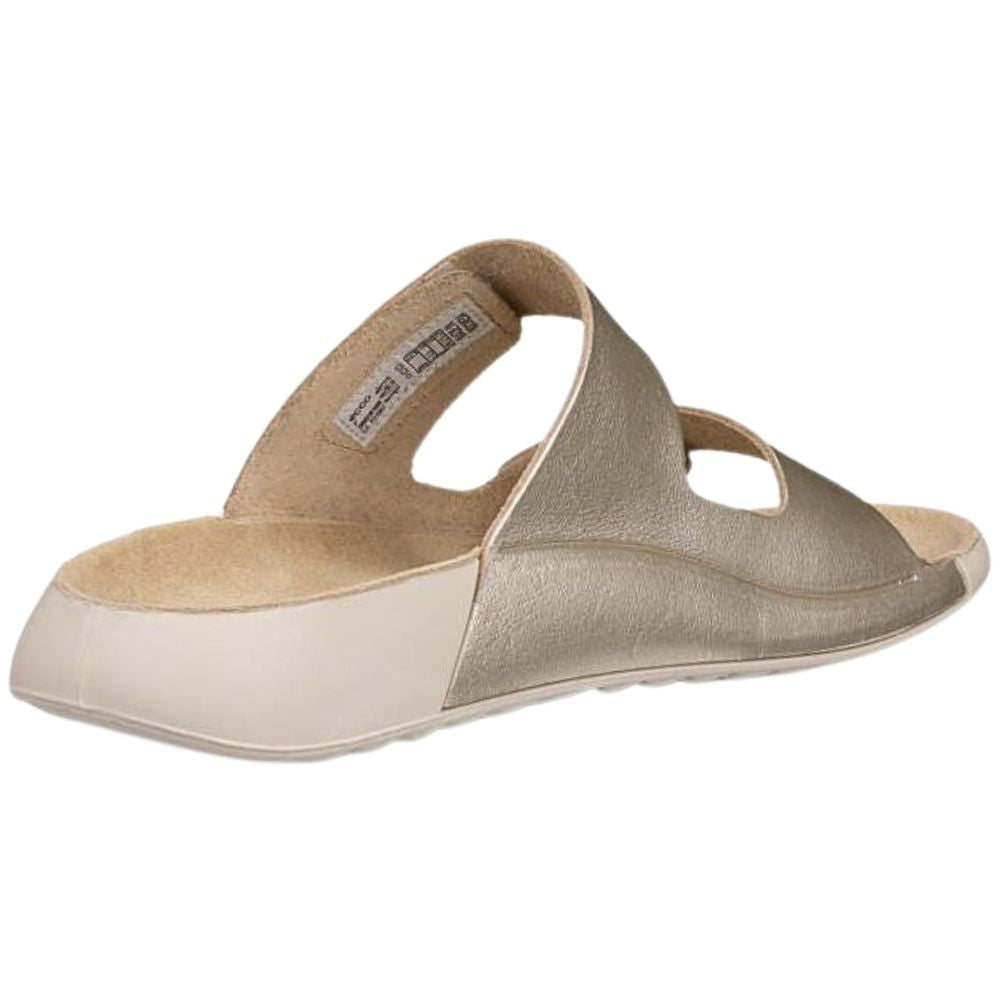 Back view of a pale gold sandal with beige sole on a white background