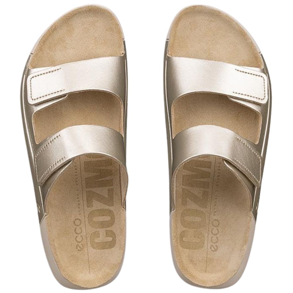 Pair of pale gold sandals with two adjustable straps and 'Ecco' branding on the insoles on a white background