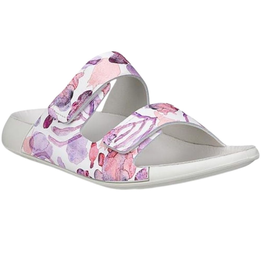 A single women's slide sandal with a white base and a watercolor floral pattern in shades of pink, purple, and light blue on the straps, shown against a plain white background.