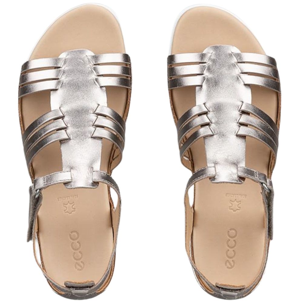 A pair of metallic pale gold strappy sandals with a tan insole, shown from a top-down view on a white background.