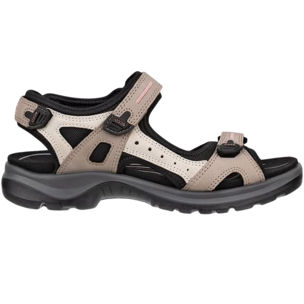 A single women's offroad sandal shown in profile against a plain white background. The sandal features a light beige/tan upper, a black footbed, and a dark gray and black sole.