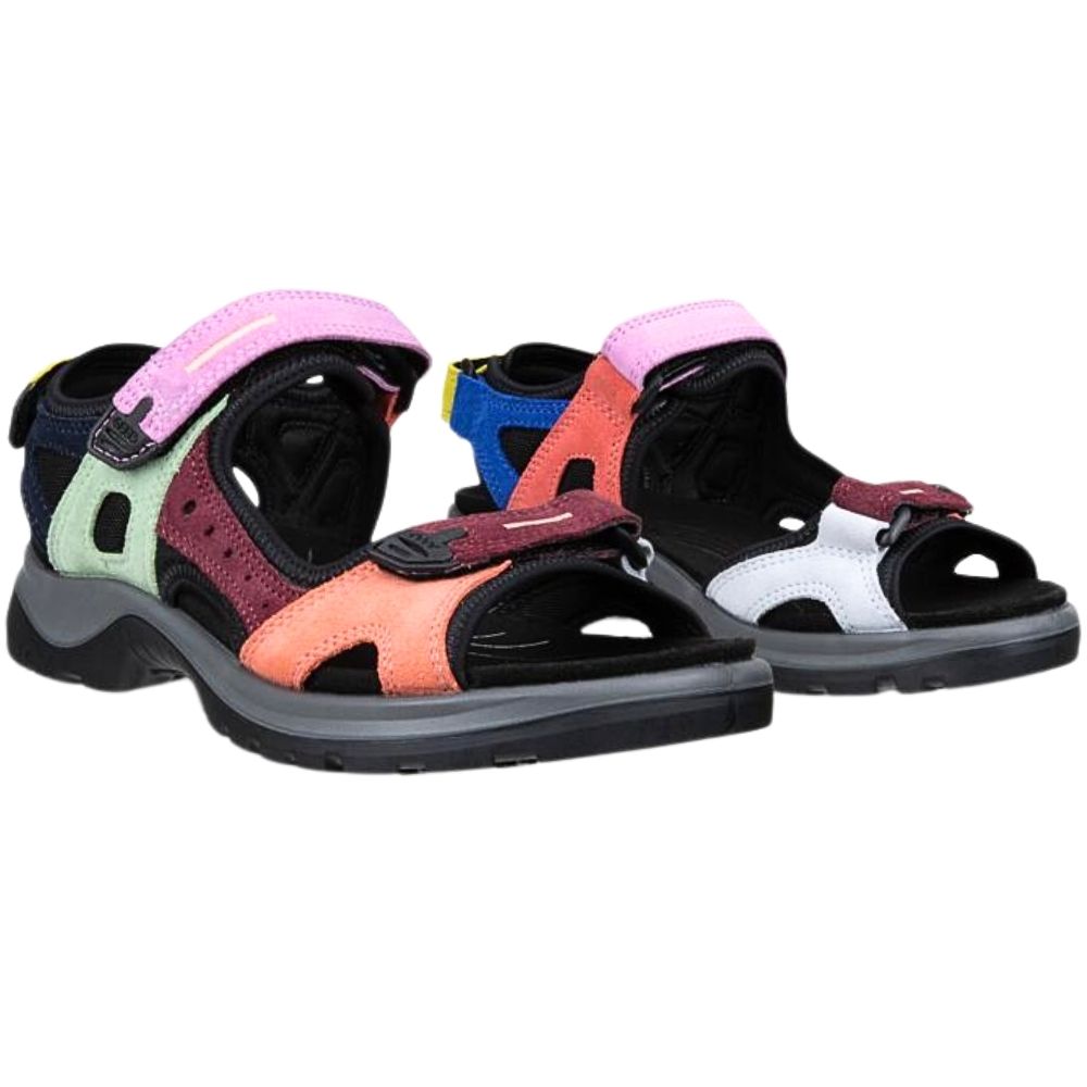 A pair of women's offroad sandals with a multicolor design, featuring black soles, pink straps, coral orange panels, a sage side panel, and a white panel on the rear sandal.