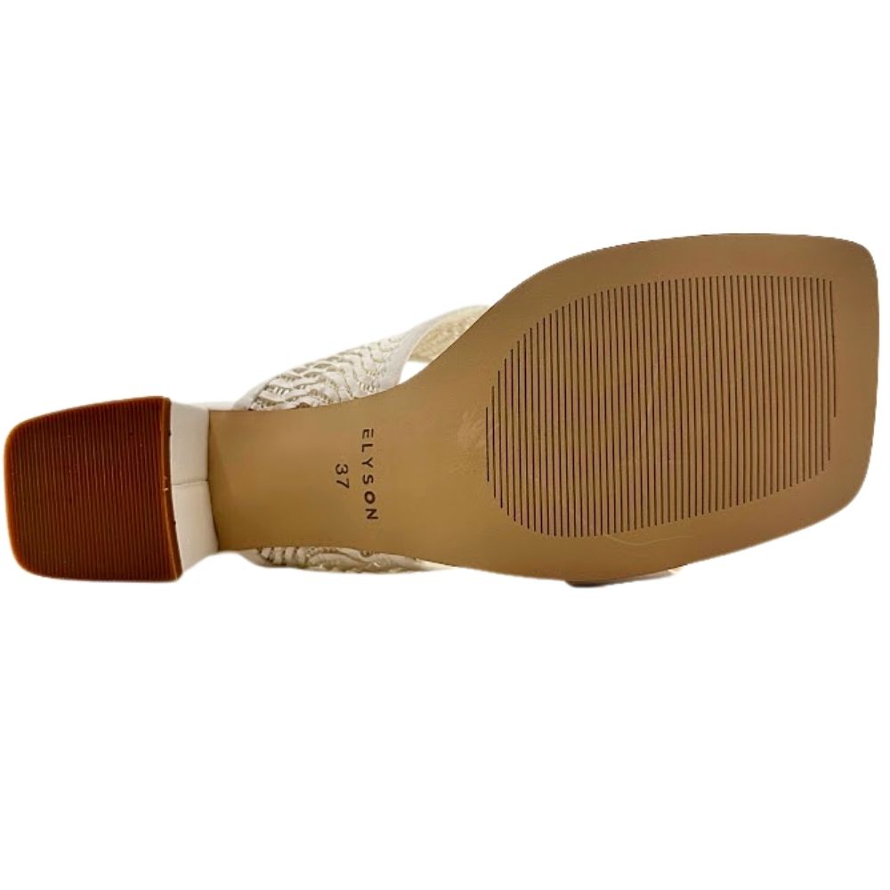 A close-up bottom view of a women's heeled sandal, showing the tan rubber outsole with the brand name 'ELYSON' printed on it, a brown block heel, and a cream woven strap.