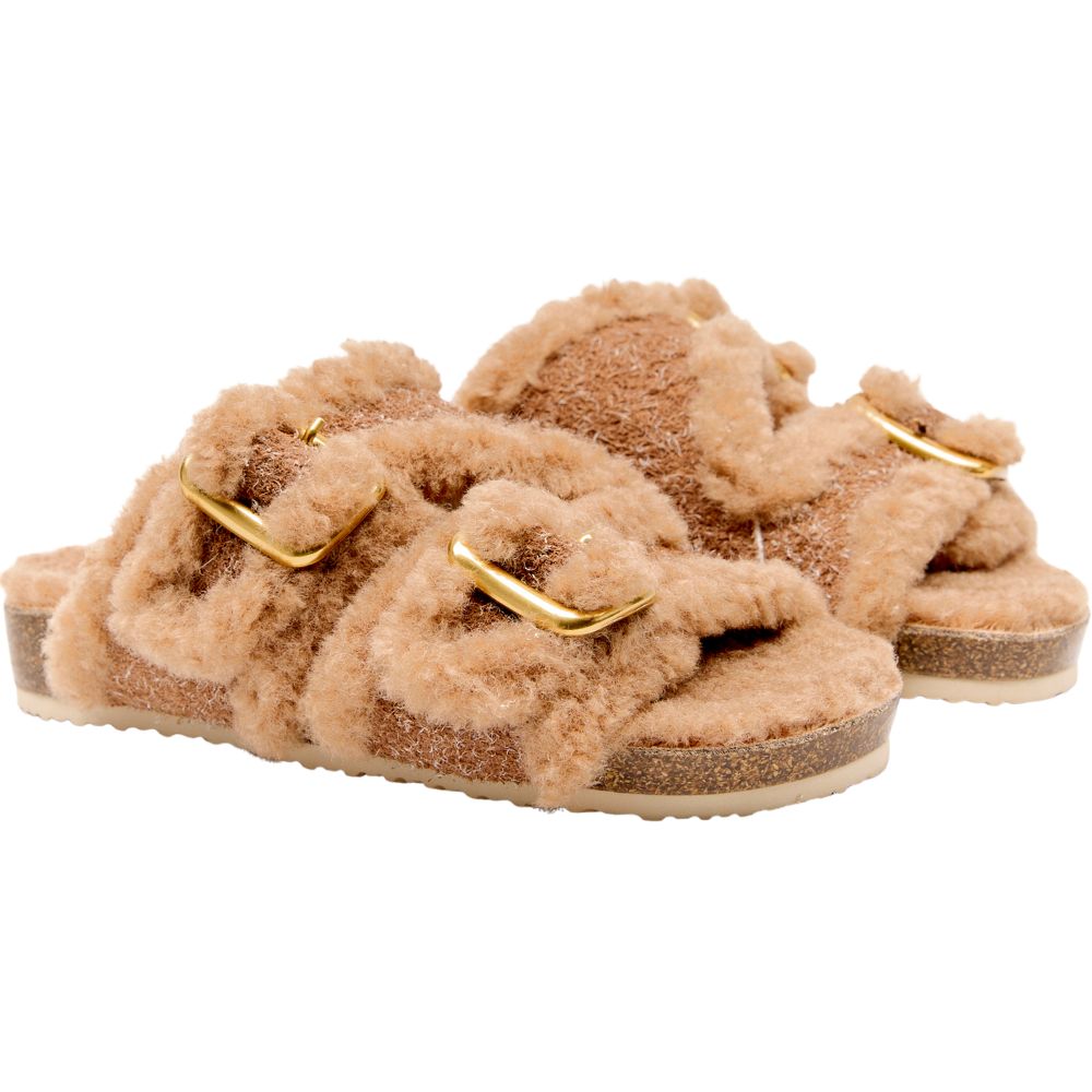 Pair of caramel leather slip-ons with fluffy lining and gold buckles on a white background