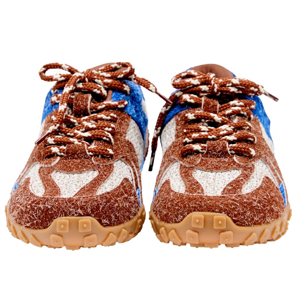 Pair of brown and blue shoes with textured soles on a white background