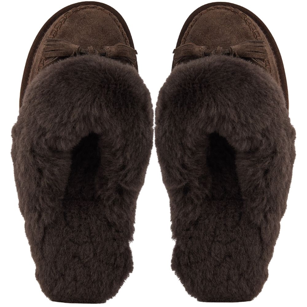 A pair of dark brown slip-on slippers with thick, sheepskin lining and tassel details on the upper, shown from a top-down view on a white background.