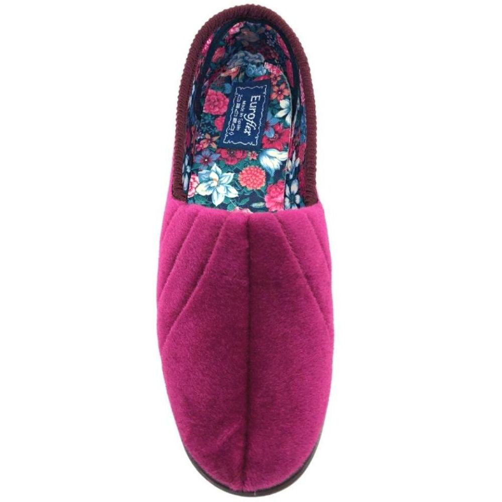 Burgundy slipper with floral lining on a white background