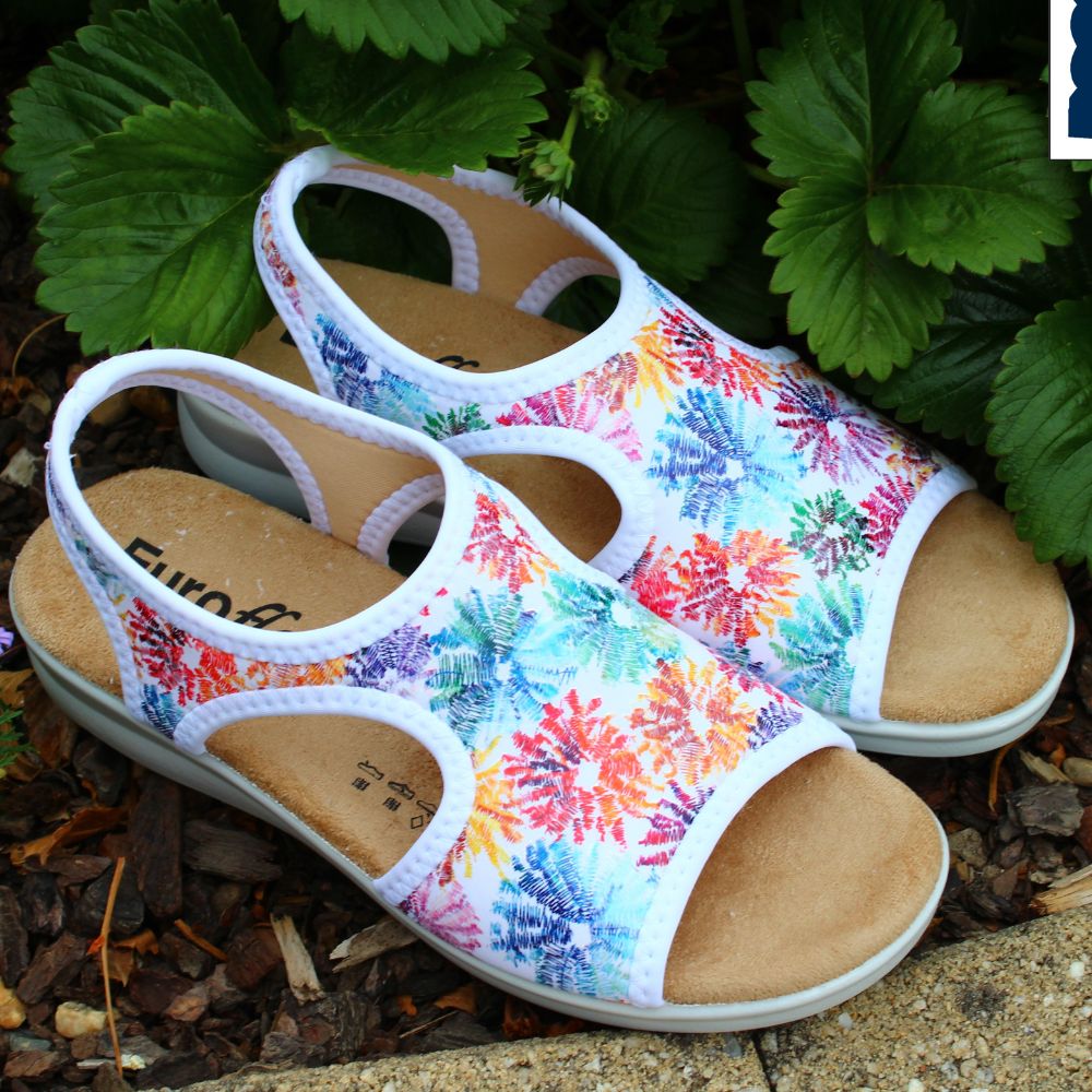 Colorful sandals with floral pattern on a natural background