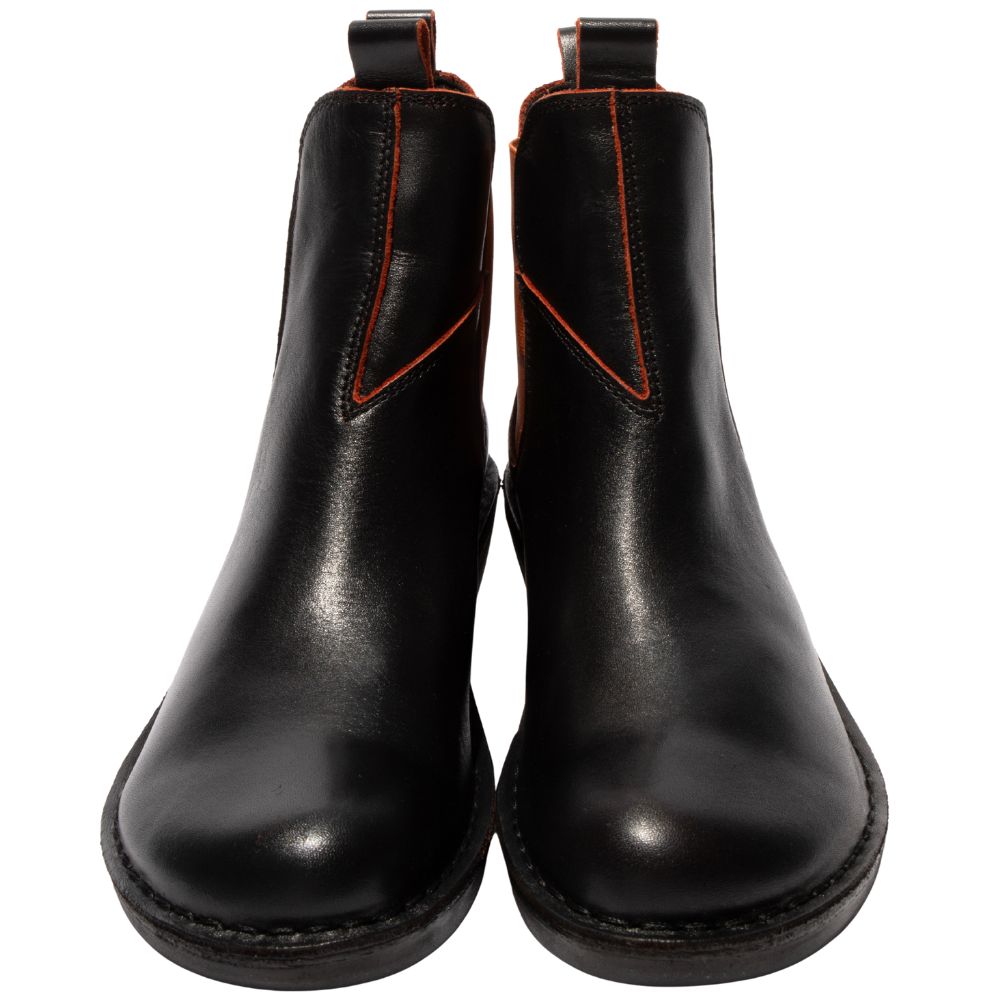 Pair of black leather Chelsea boots with brick coloured stitching on a white background