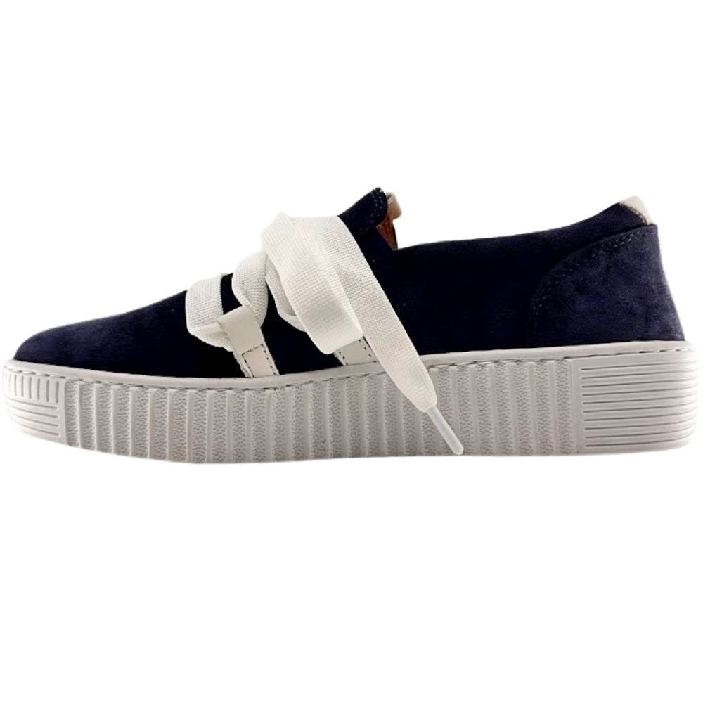 Navy blue suede sneaker with a decorative white lace and cleated sole on a white background.