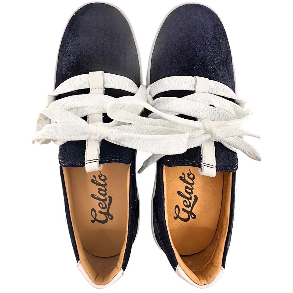 Navy blue suede sneakers with decorative white laces, from a top-down perspective on a white background.