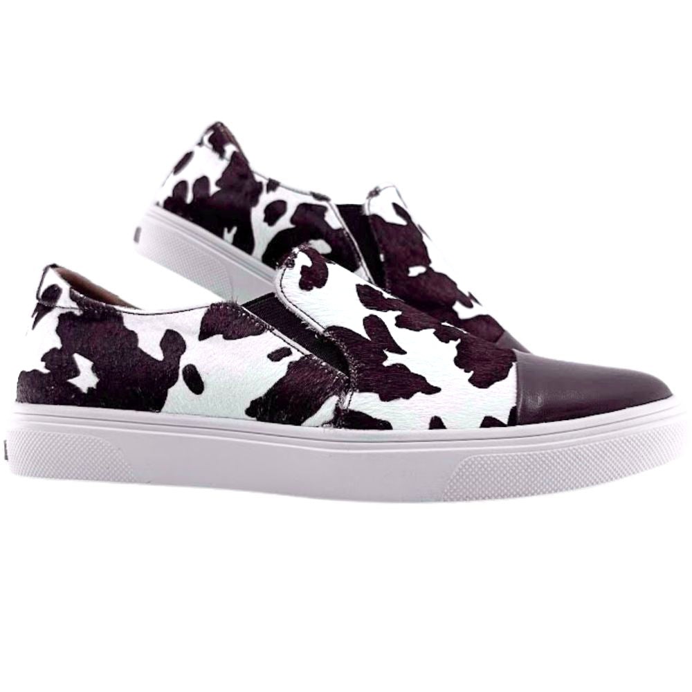 Brown and white cow print slip on loafer sneakers on a white background