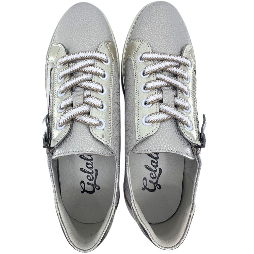 Pair of gold leather sneakers with white laces on a white background