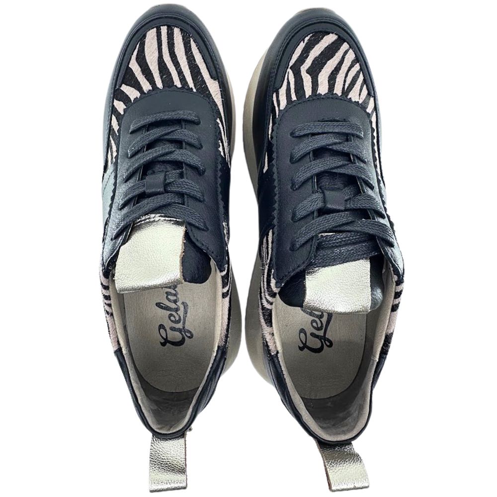 Pair of black and tan zebra-striped sneakers on a white background