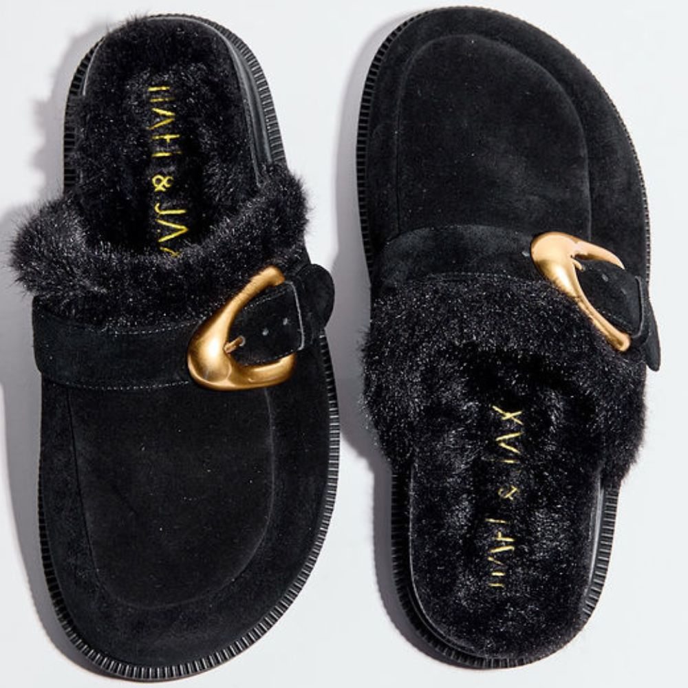 Black suede leather mules with fur lining and gold buckles on a white background 