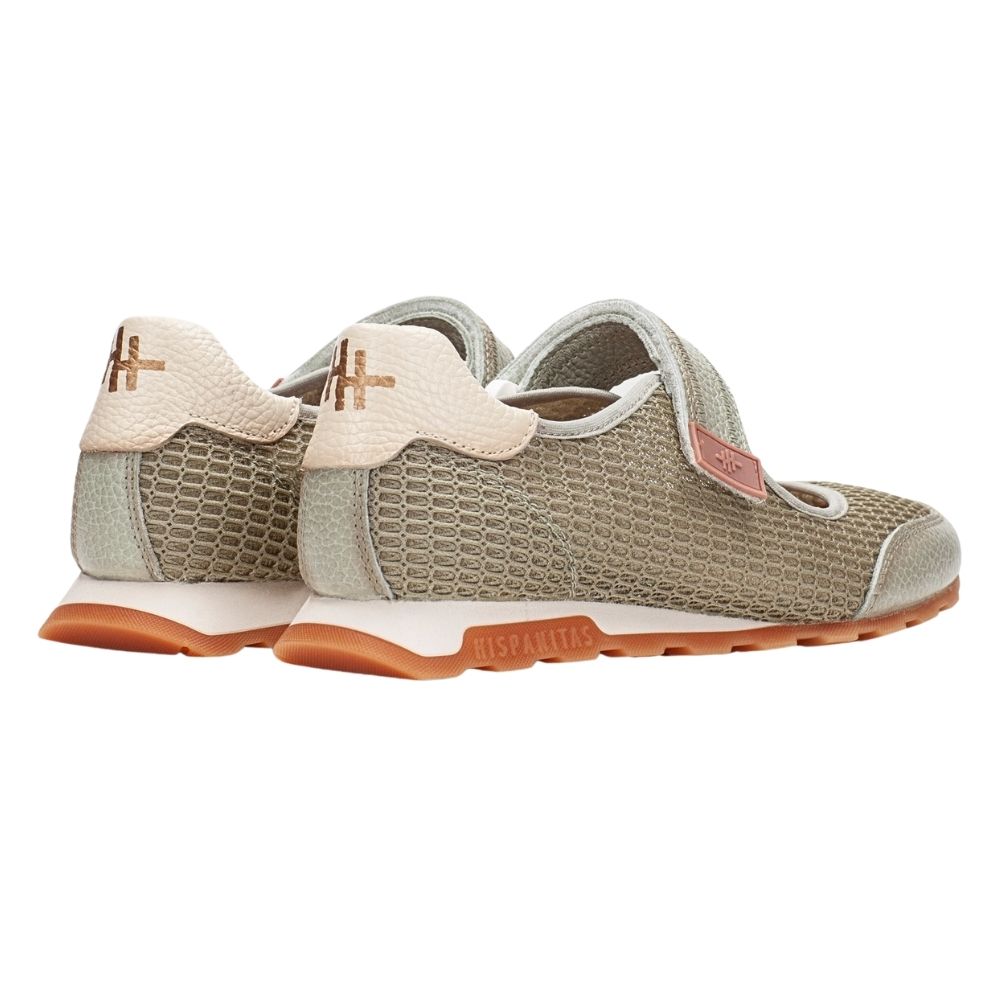 The back view of a pair of women's Mary Jane shoes in a light sage textured mesh and leather, featuring hook-and-loop straps, cream heel counters, and tan rubber soles with the brand name 'Hispanitas'.