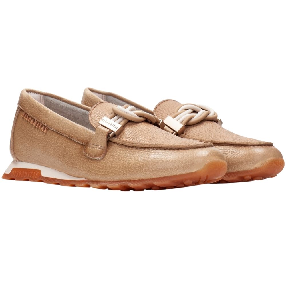 A pair of tan pebbled leather slip-on loafers with decorative braided details across the vamp and a gum rubber sole, shown against a plain white background.