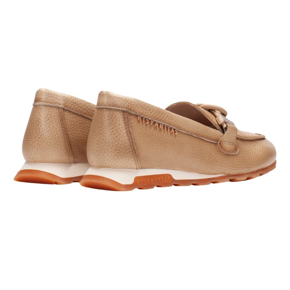 A pair of tan pebbled leather slip-on loafers with a decorative strap detail on the vamp, a white midsole, and a brown outsole, shown against a plain white background.