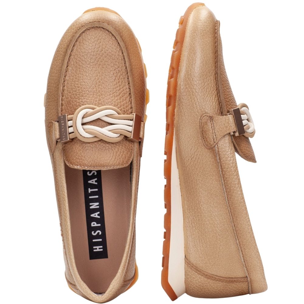 A pair of tan leather slip-on loafers shown from the top and side views on a white background. The shoes feature a decorative braided strap detail across the top and a black insole with the brand name 'HISPANITAS' printed in white.