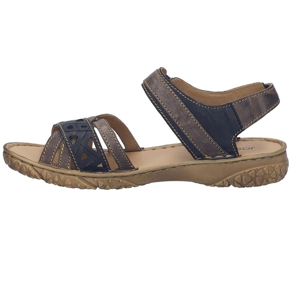 A women's strappy sandal with dark navy blue and brown textured straps, a tan footbed, and a brown textured outsole, shown from a side profile on a white background.